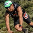Karjan Alves subindo um trecho rochoso durante uma corrida de trilha